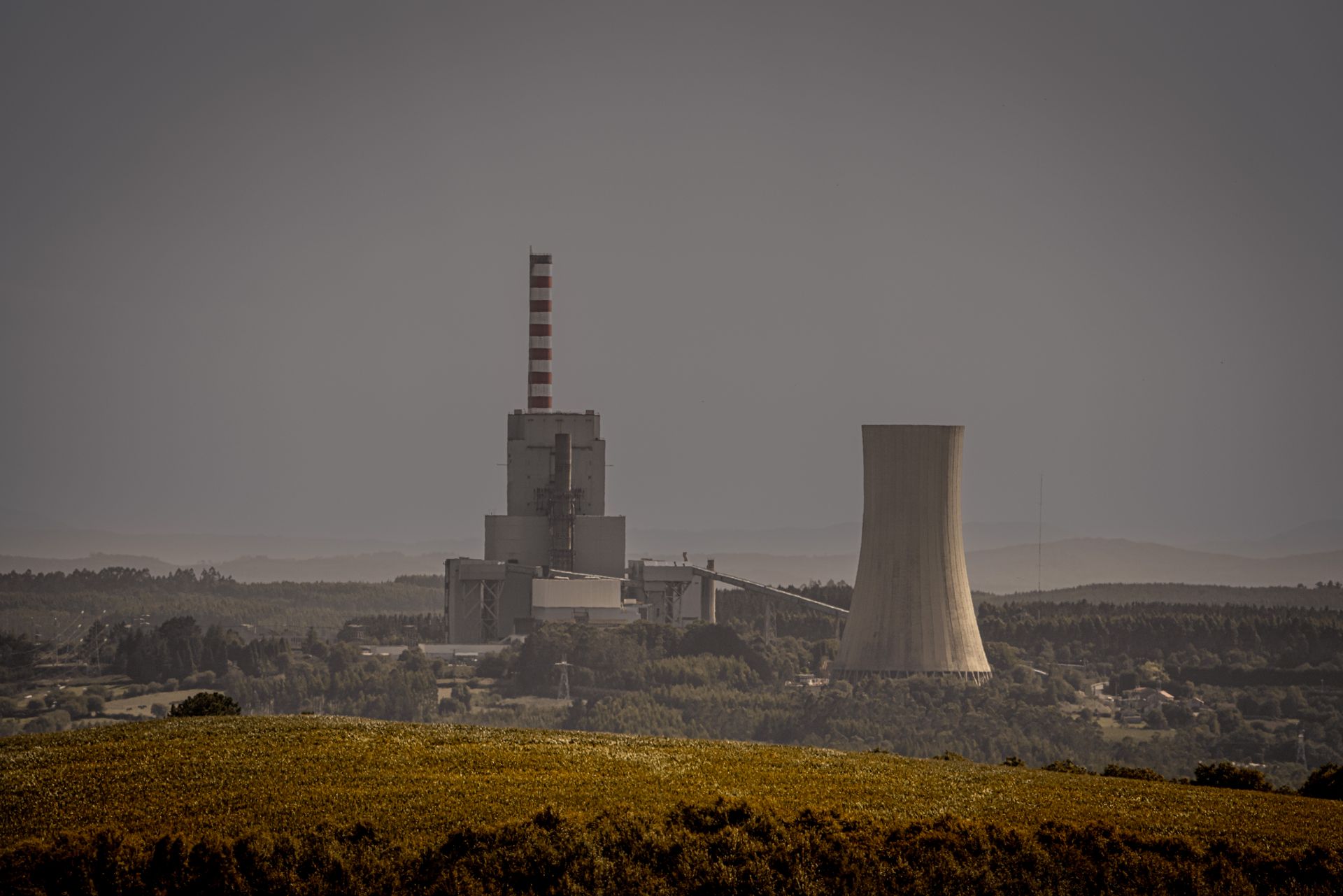 Power generation plant with transmission infrastructure at dusk