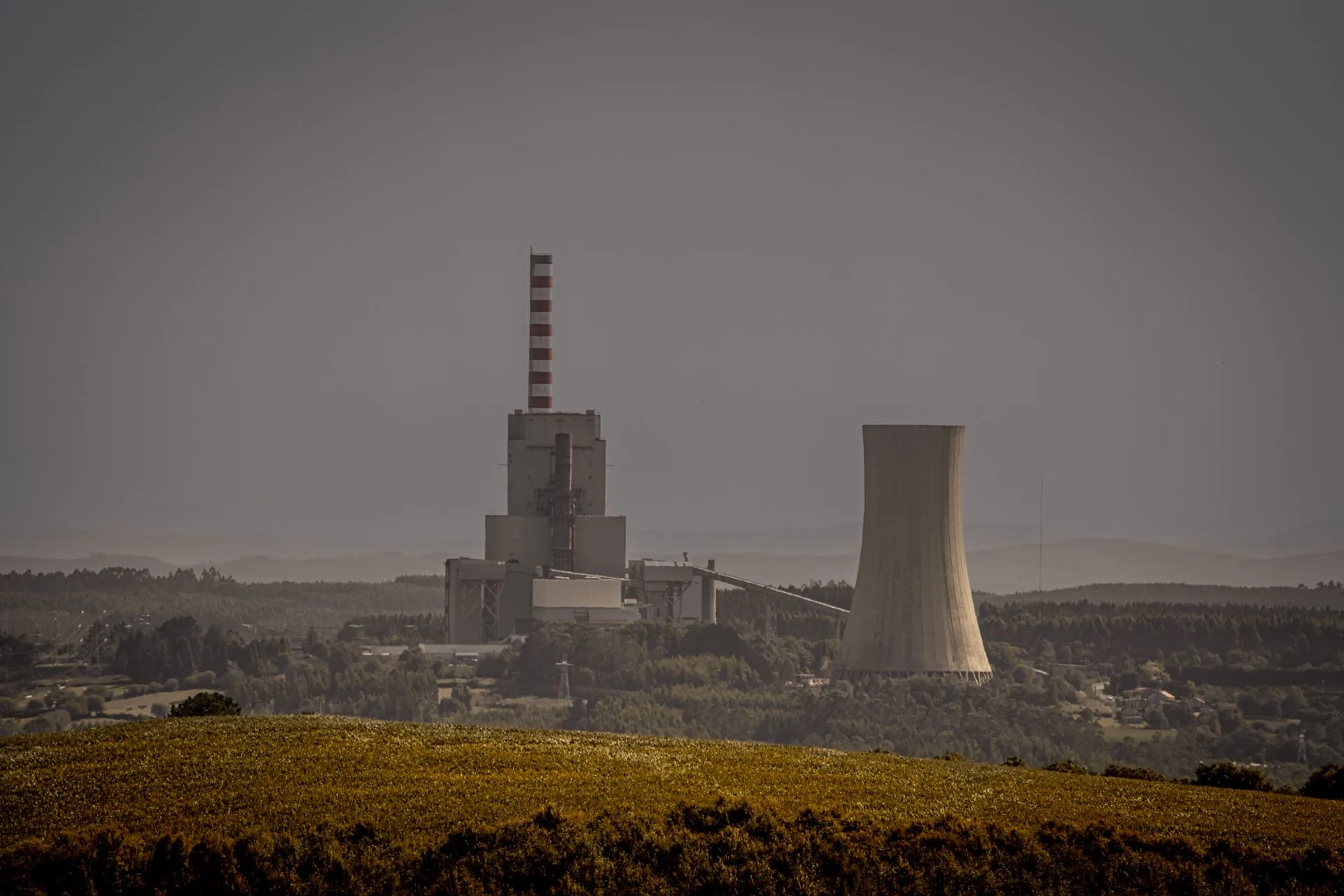 Power generation plant with transmission infrastructure at dusk